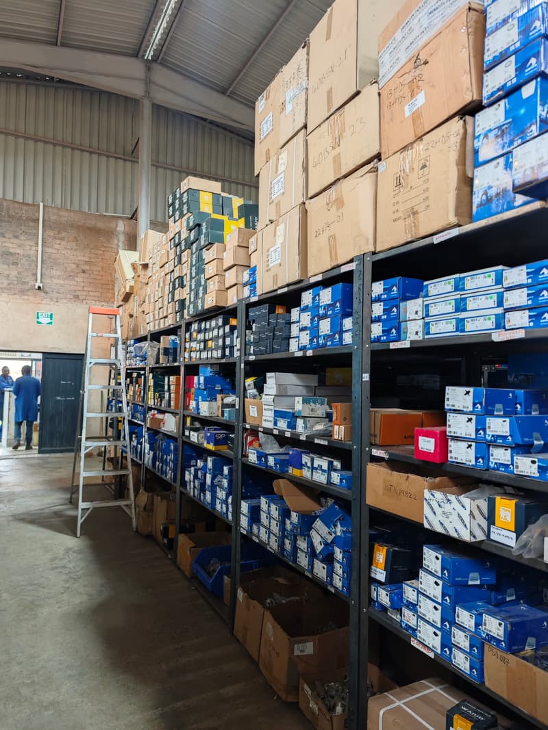 Warehouse worker with organised parts shelving
